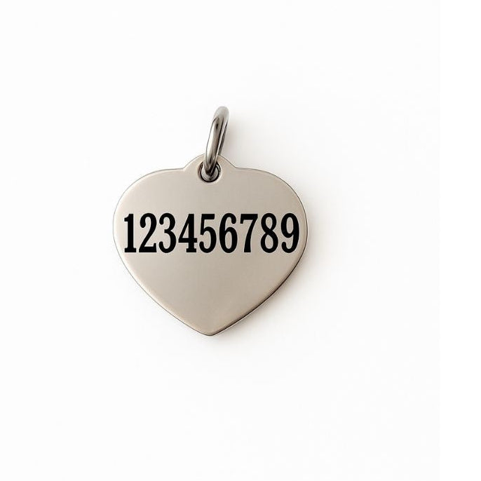 Heart-shaped metal tag with numbers engraved on a white background